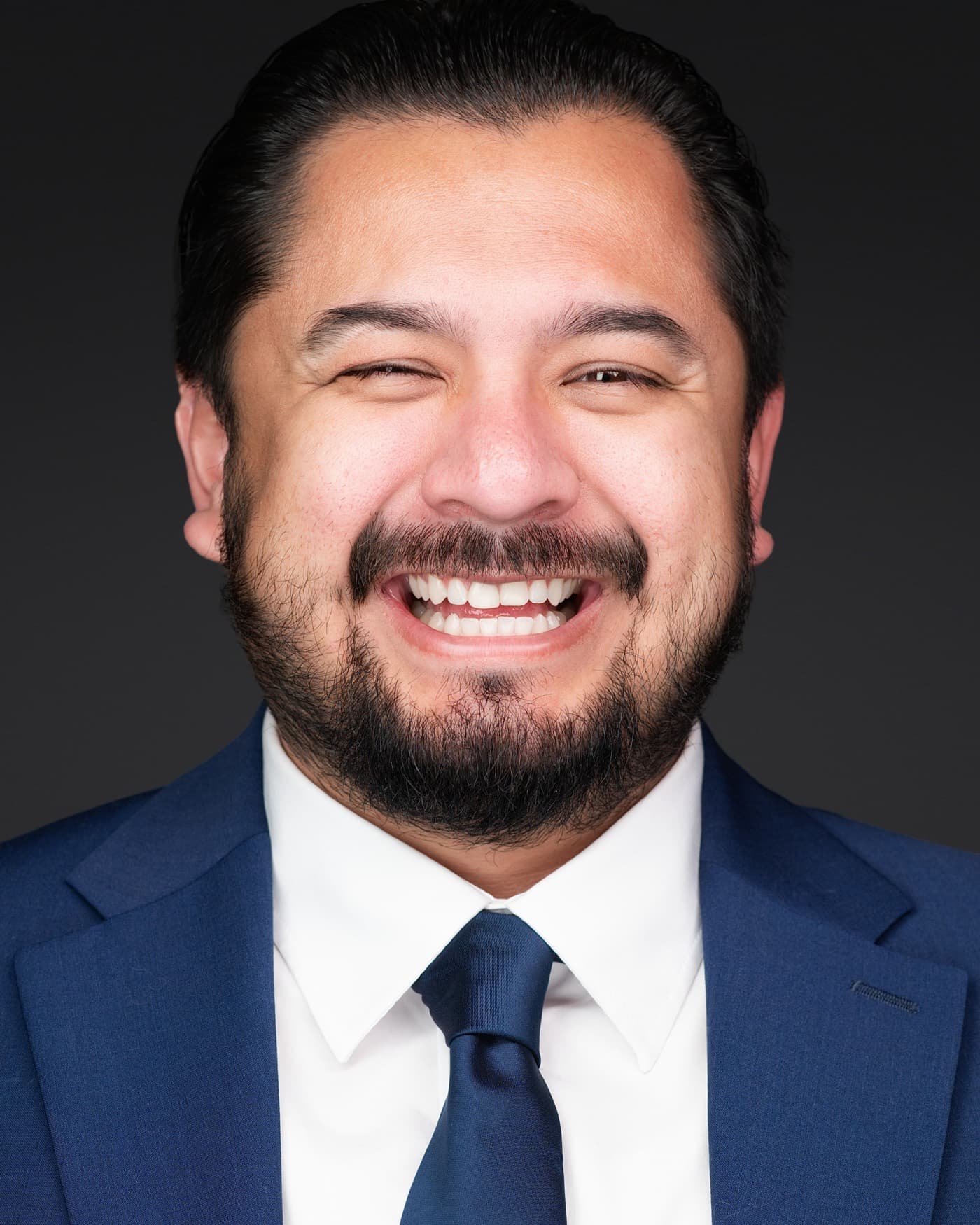 Set of individual booth headshots, each person smiling against a white background.