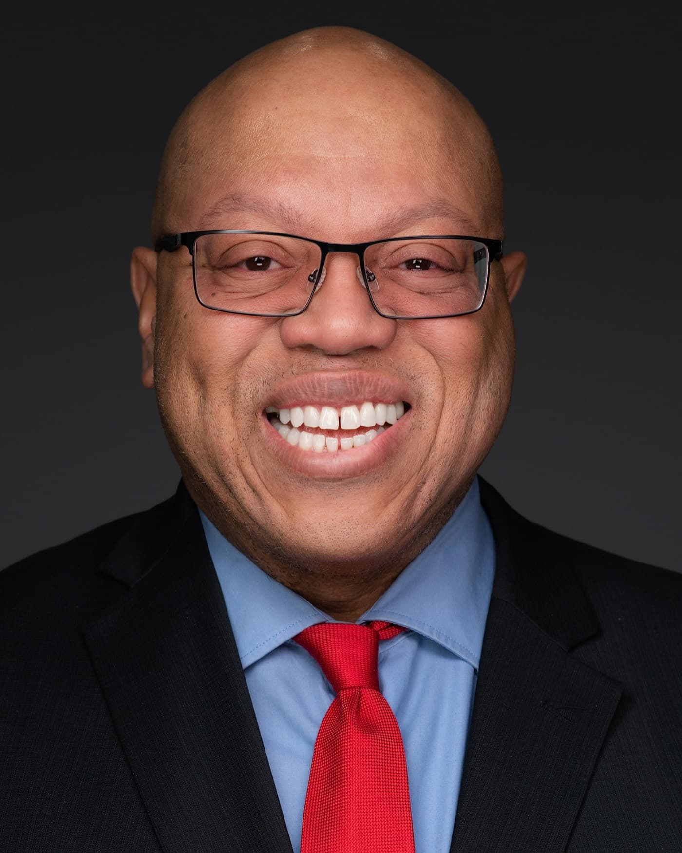 Set of individual booth headshots, each person smiling against a white background.