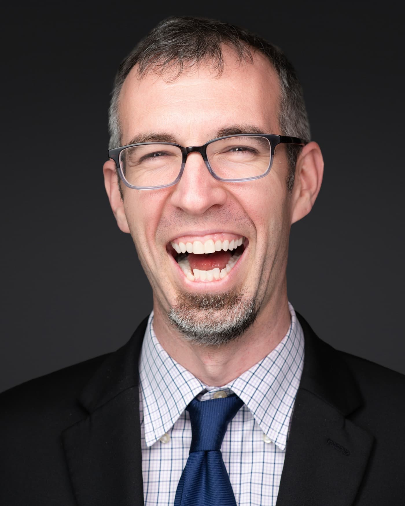 Set of individual booth headshots, each person smiling against a white background.