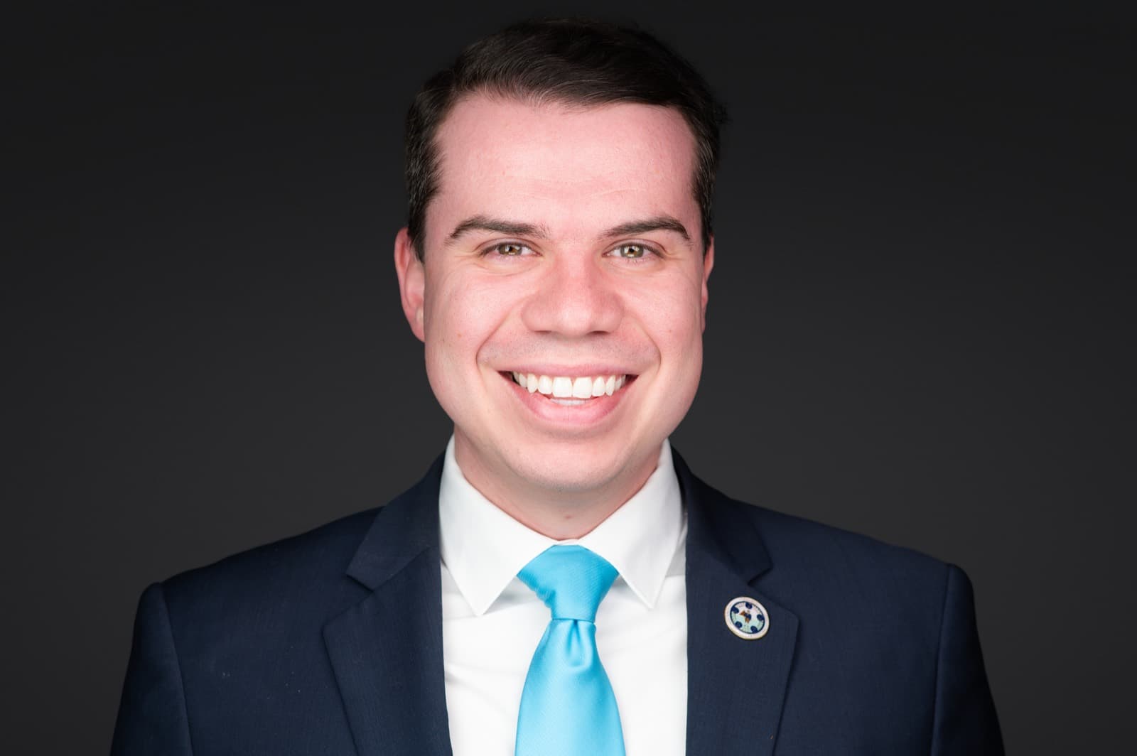Set of individual booth headshots against a dark charcoal background.
