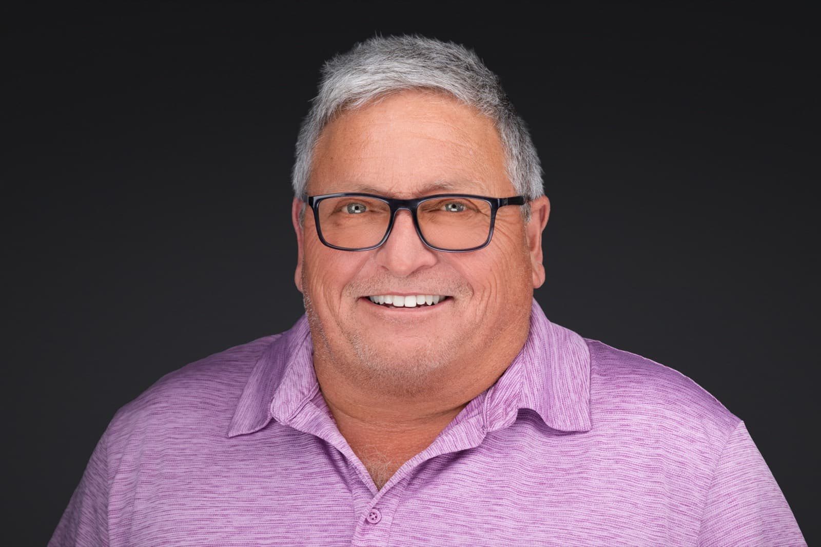 Set of individual booth headshots against a dark charcoal background.