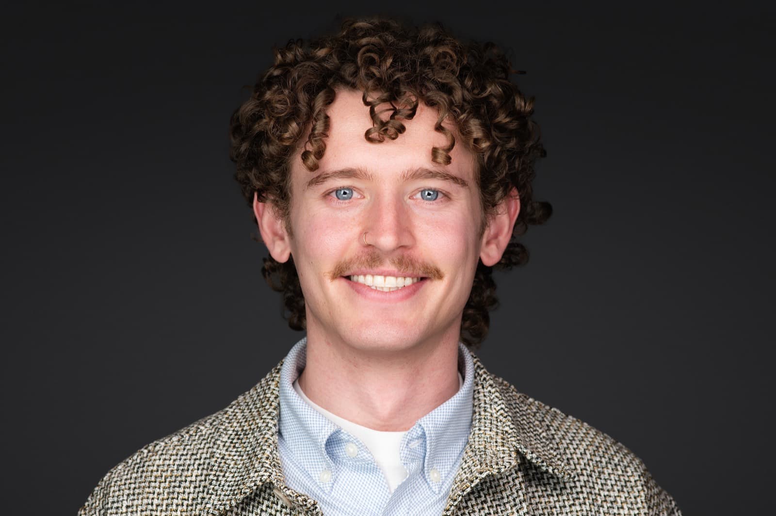 Set of individual booth headshots against a dark charcoal background.