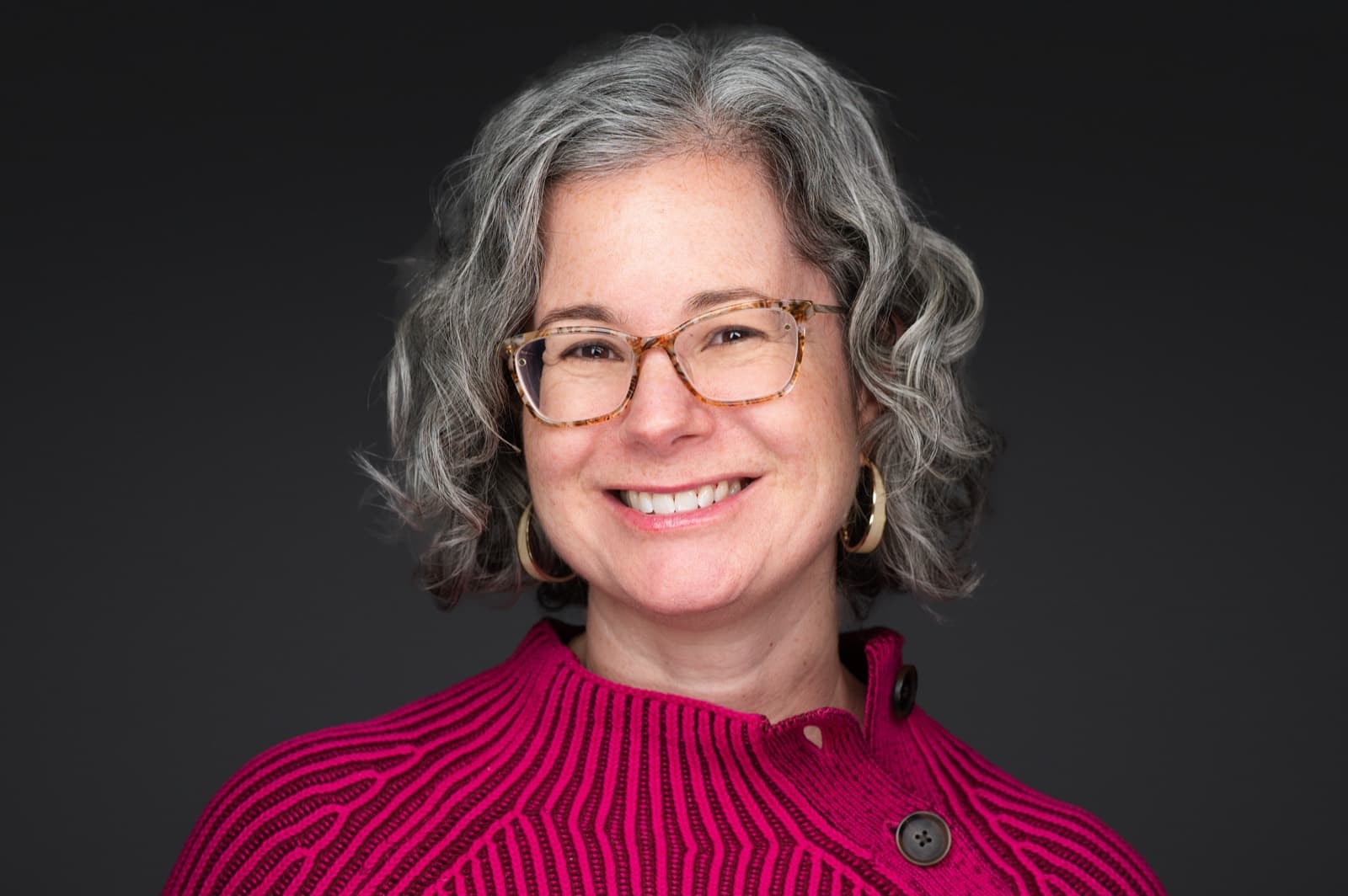 Set of individual booth headshots against a dark charcoal background.