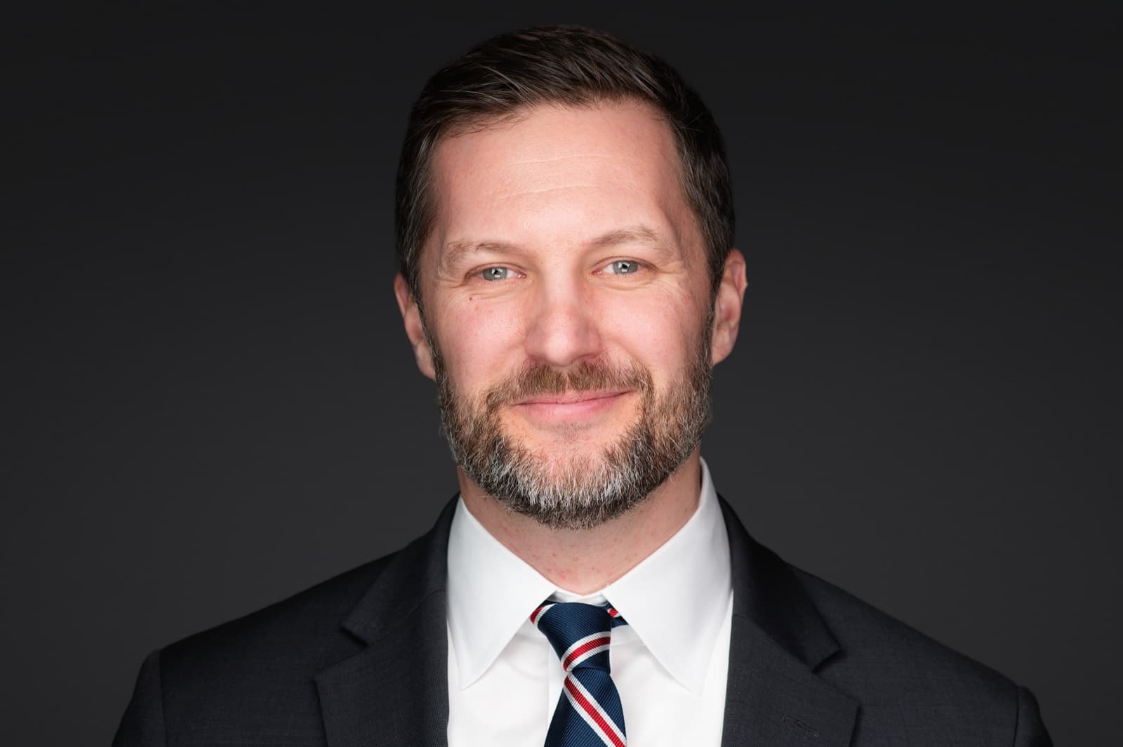 Set of individual booth headshots against a dark charcoal background.