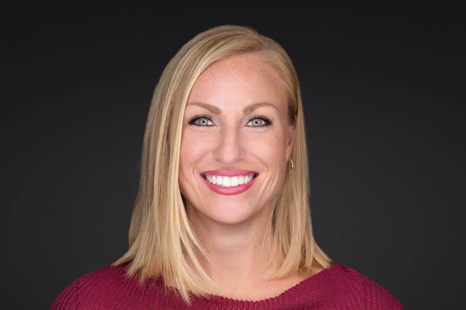 Set of individual booth headshots against a dark charcoal background.