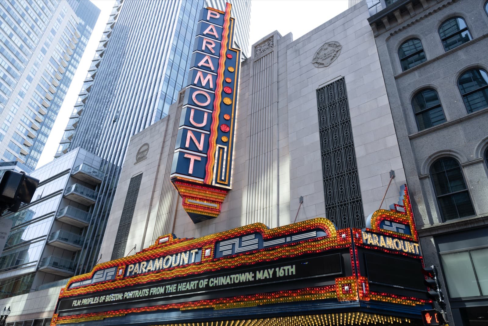 A theater marquee lit up at night, advertising a film screening on May 16th.