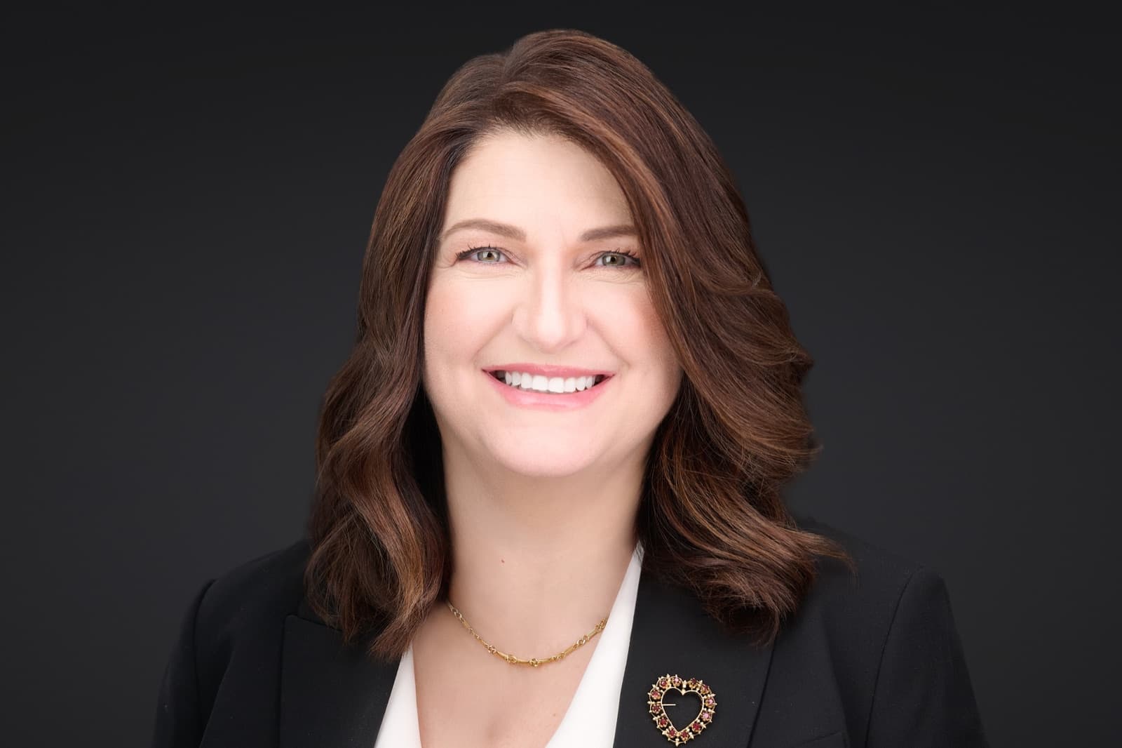 Set of individual headshots taken during a session, smiling professionals against a white background.