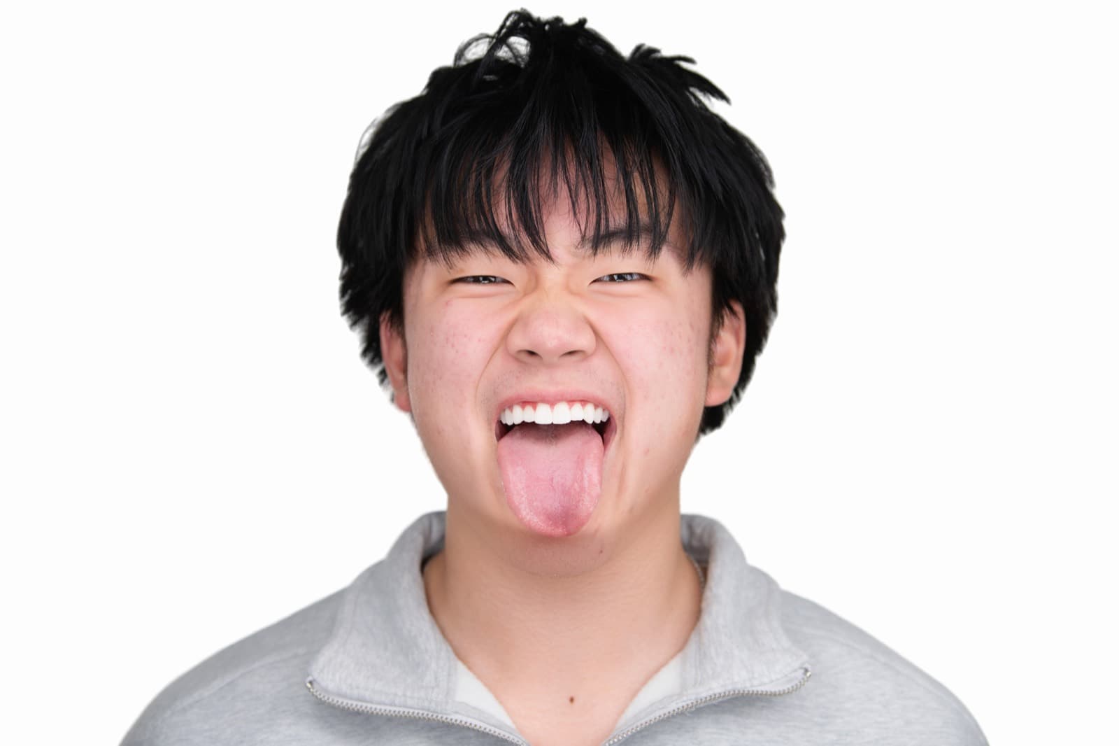 Set of individual booth headshots with playful expressions, including one person sticking out their tongue.