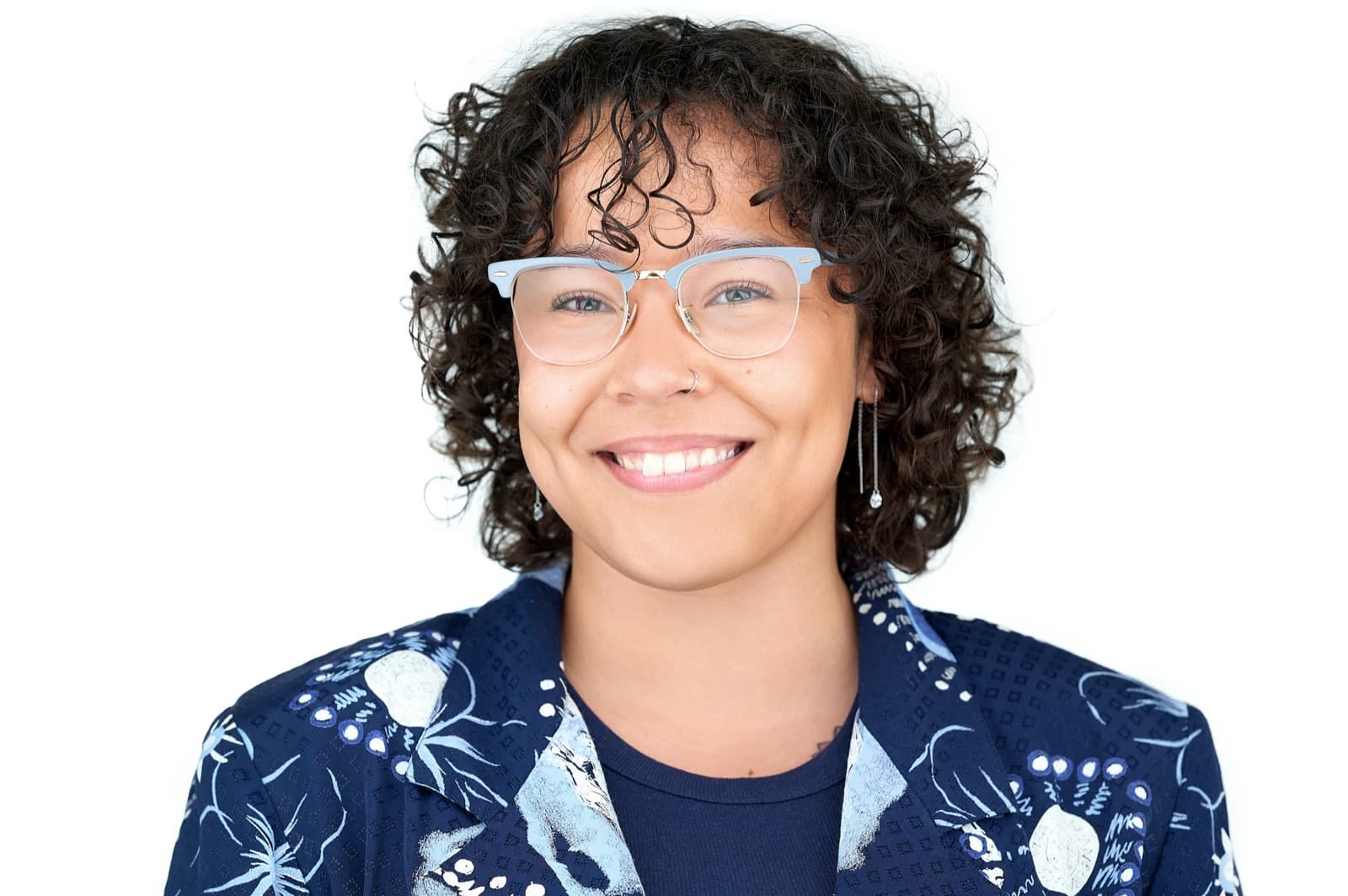 Set of individual headshots against white and gray studio backdrops, smiling professionals in business attire.