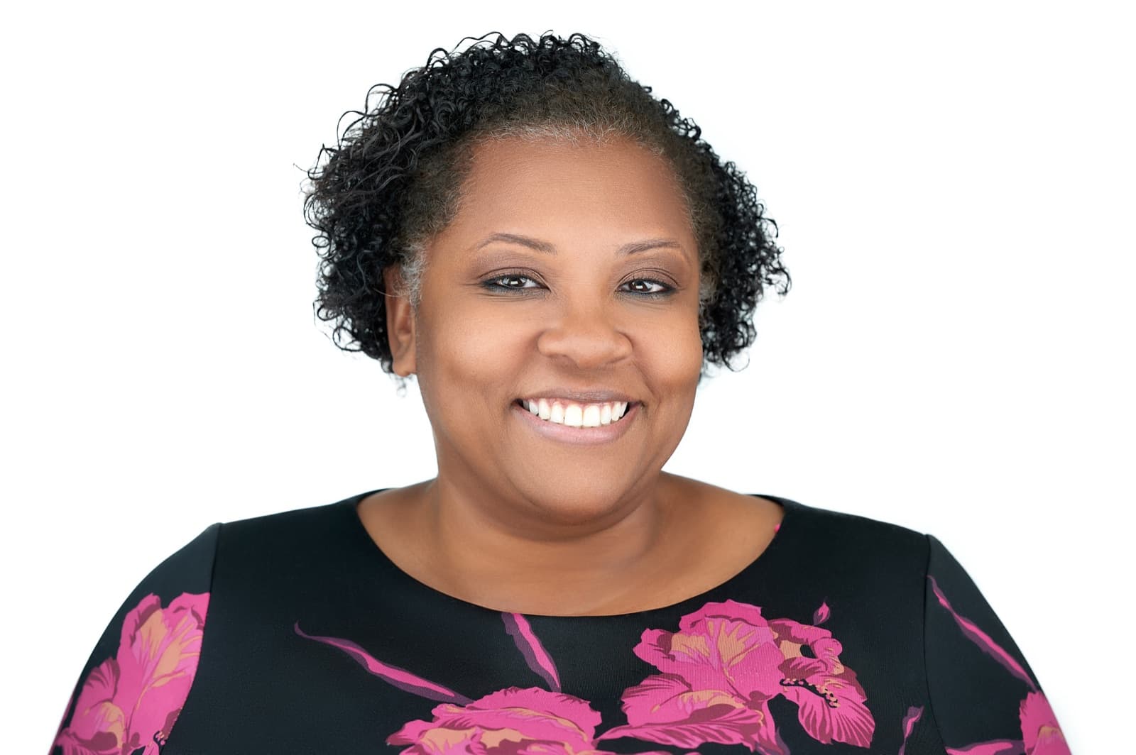 Set of individual headshots against white and gray studio backdrops, smiling professionals in business attire.