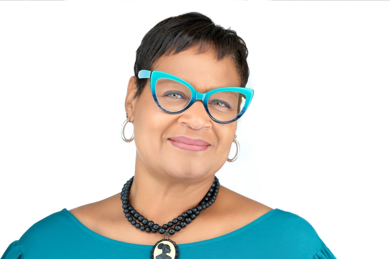 Set of individual headshots against white and gray studio backdrops, smiling professionals in business attire.