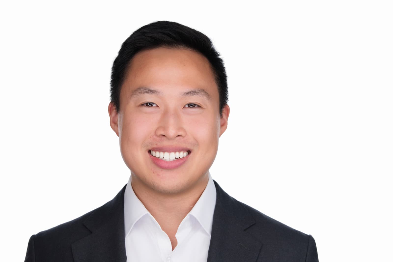 Set of individual booth headshots against a dark background, one wearing an event pin.